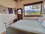 Downstairs queen bedroom with backyard mountain views